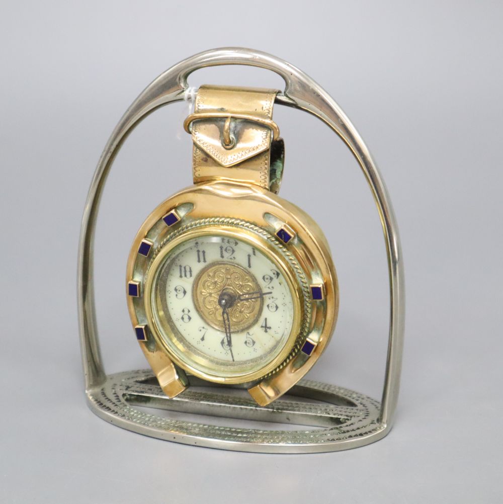 A late Victorian British United Clock Company brass and enamel horseshoe desk timepiece with plated stirrup stand, height 14cm